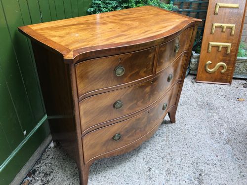 fig 2. Early C19th Regency period mahogany serpentine-outline chest of drawers .