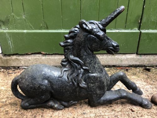 fig 2. Pair of mid C19th cast-iron boot-scrapers in the form of a recumbent lion and a unicorn .