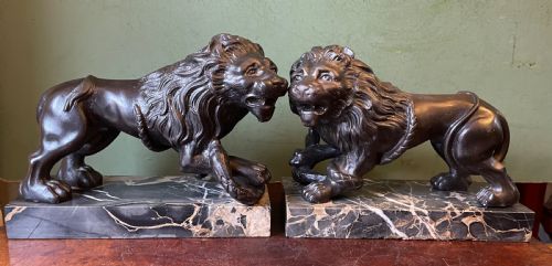 fig 1. Pair of C19th French cast-iron lions with a bronze patination, mounted on portoro marble plinth bases .