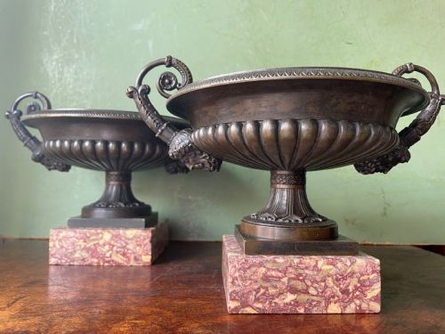 fig 1. A pair of 19th-century dark bronze tazzas featuring gadrooned bowls and scroll handles, each mounted on a square red mottled marble base.