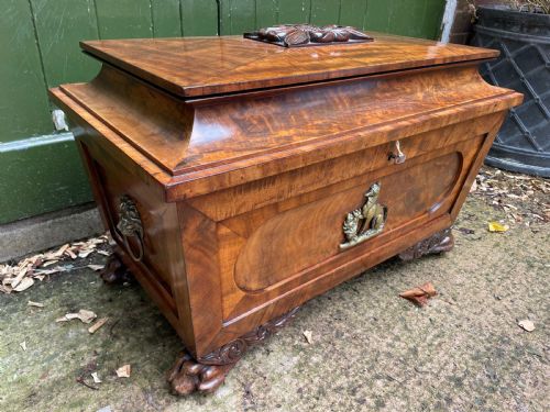 fig 2. Early C19th Regency period brass-mounted mahogany cellarette or wine-cooler of classical sarcophagus form with a noble armorial .