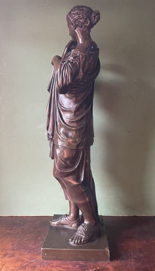 fig 1. A 19th-century dark bronze sculpture depicting the classical figure of Diane de Gabii adjusting her draped robe.
