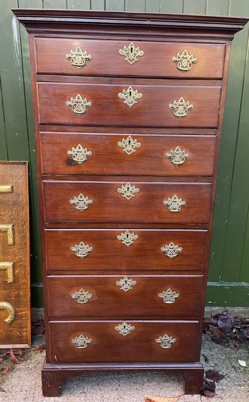 fig 1. A mid-18th-century George III mahogany tallboy chest comprising seven graduated drawers with decorative pierced brass handles and bracket feet.