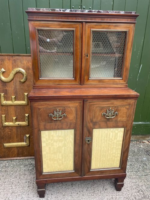 fig 1. Elegant early C19th small-scale mahogany 4 door 2-part glazed cabinet having brass line inlay and brass mouldings , together with a ‘rosso levanto’ marble top.