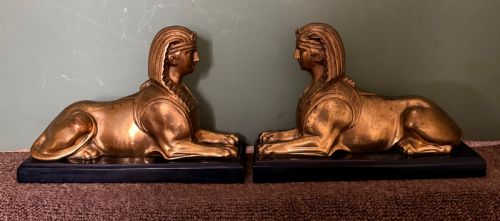 PAIR OF EARLY C19TH GILDED BRONZE STUDIES OF RECUMBENT SPHINXES ON RECTANGULAR PATINATED BRONZE PLINTH BASES