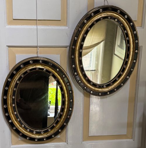 fig 1. Scarce pair of early C19th Irish oval ebonised , parcel-gilt and glass cabochon mounted mirrors of smaller scale .