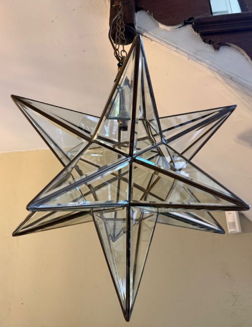fig 1. An early twentieth-century twelve-point Moravian star pendant lantern featuring a brass frame with clear bevelled glass panels and a chain drop.