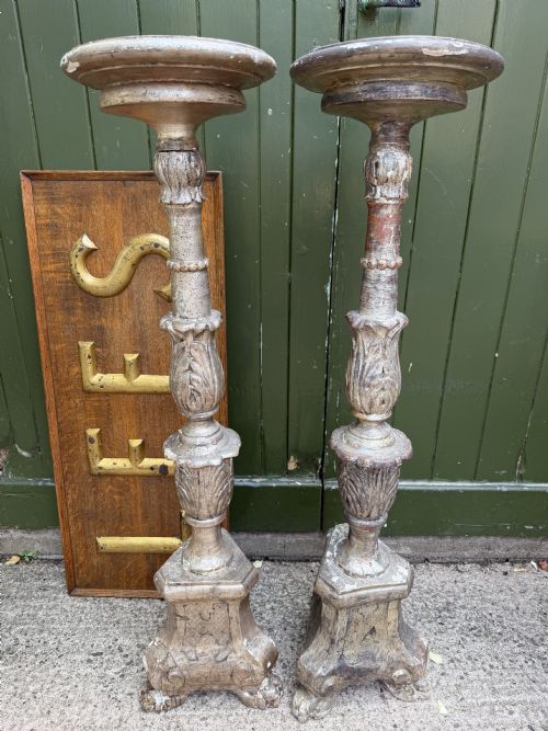fig 1. A pair of tall 18th-century Italian carved wood torcheres featuring baluster turned shafts with acanthus leaf details and an aged silver leaf finish.