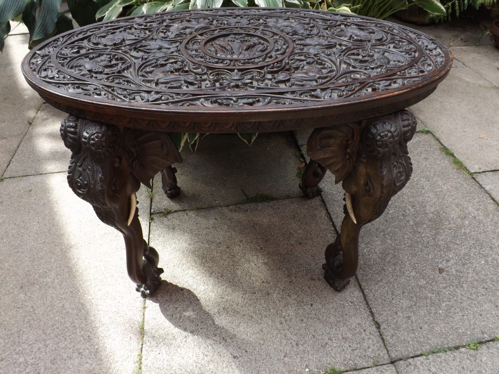 C19th carved teak Indian or Burmese oval elephant- support table