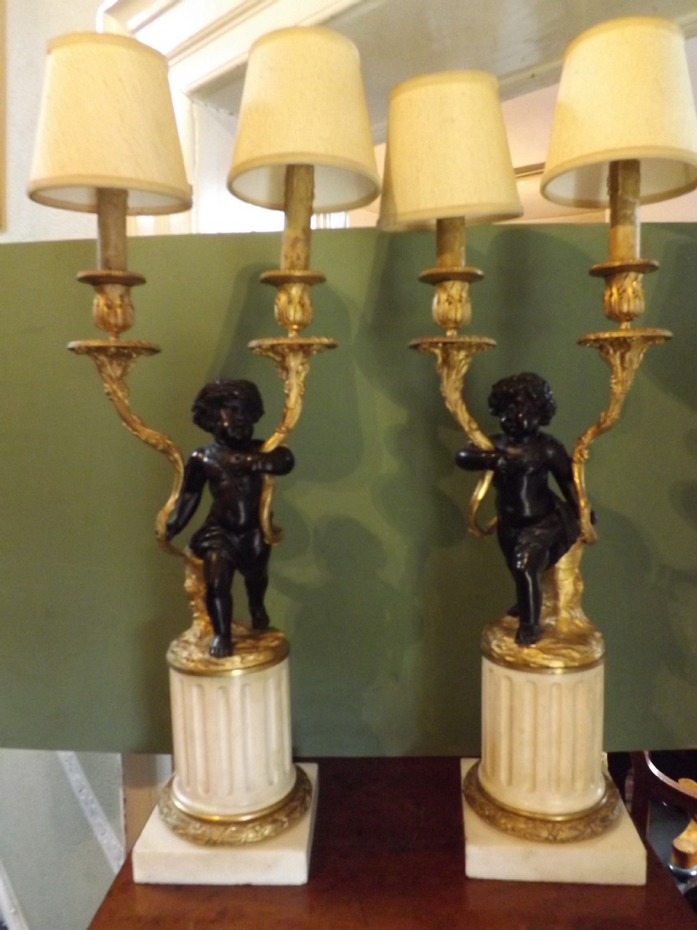 Pair C19th French bronze cherub candelabras of Louis XVI style in the manner of Clodion.