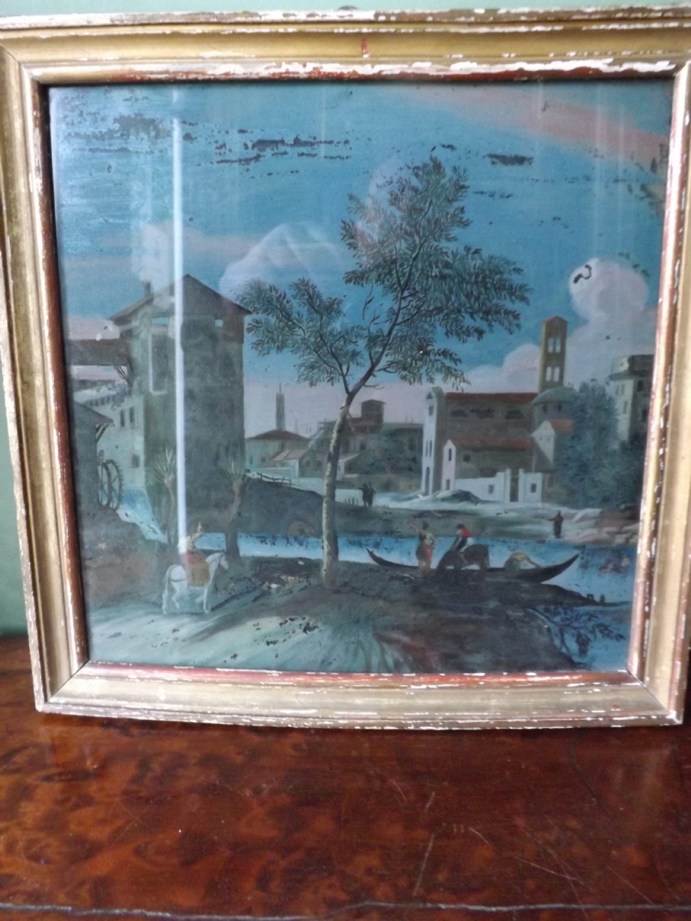 Late C18th Italian reverse-painted glass picture in gilt-wood frame.