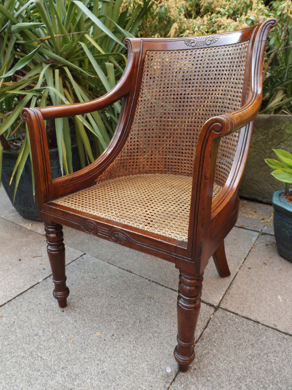 C19th Regency period mahogany 'bergere' library armchair