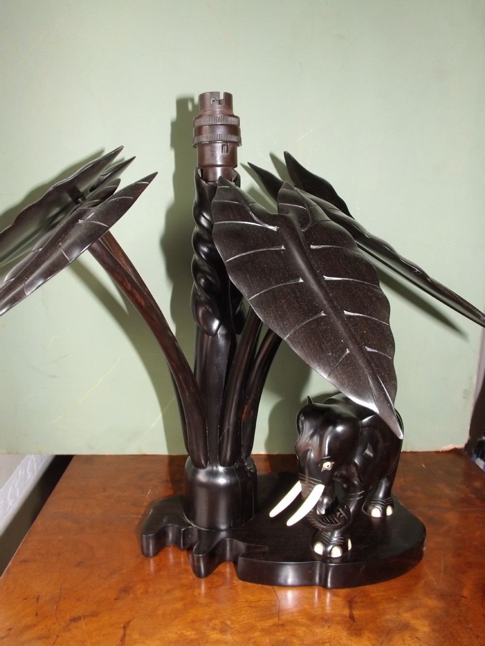 Early C20th Anglo-Indian carved ebony elephant lamp-base.