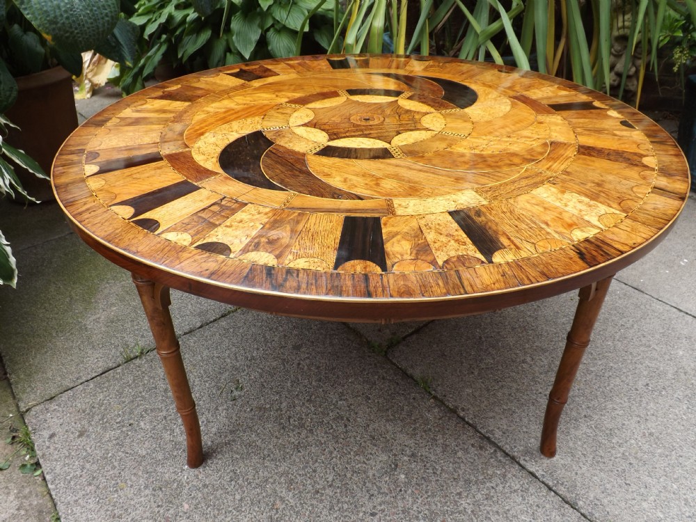 Early C19th circular top specimen-wood veneered table on low base.