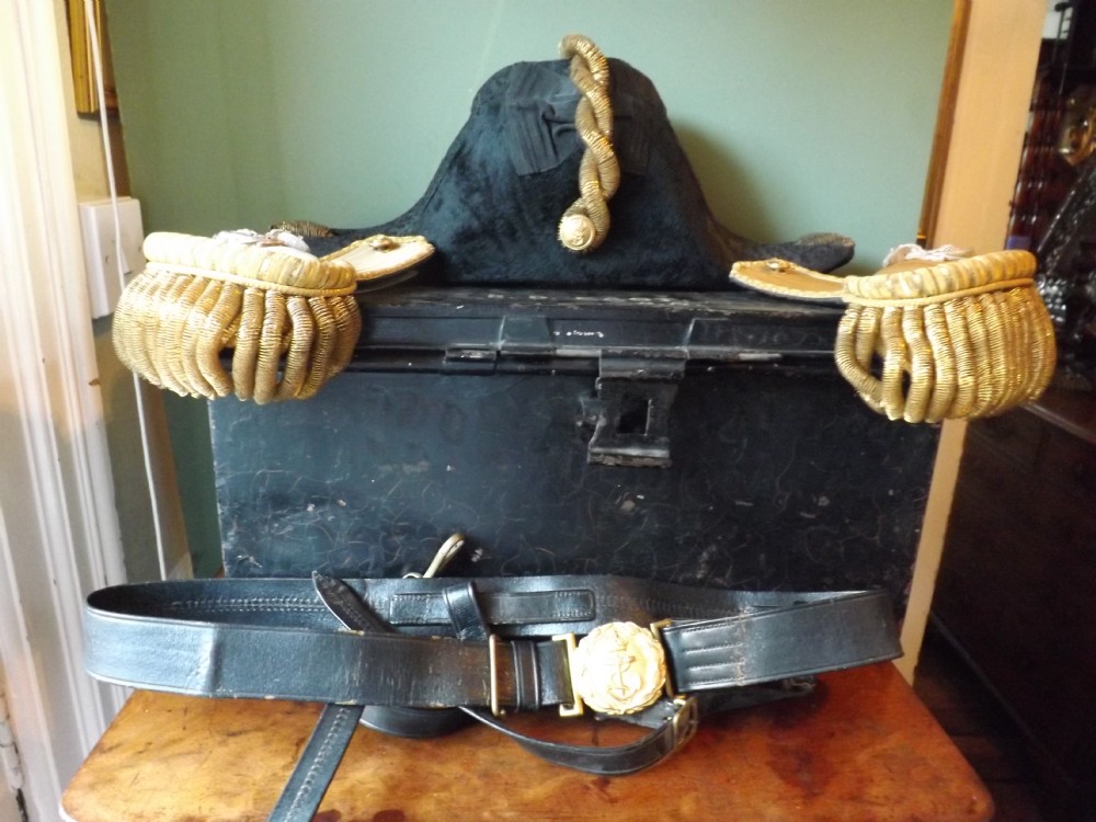 Early C20th Royal Naval officer's bicorn hat, epaulettes and sword-belt in a fitted service tin. 