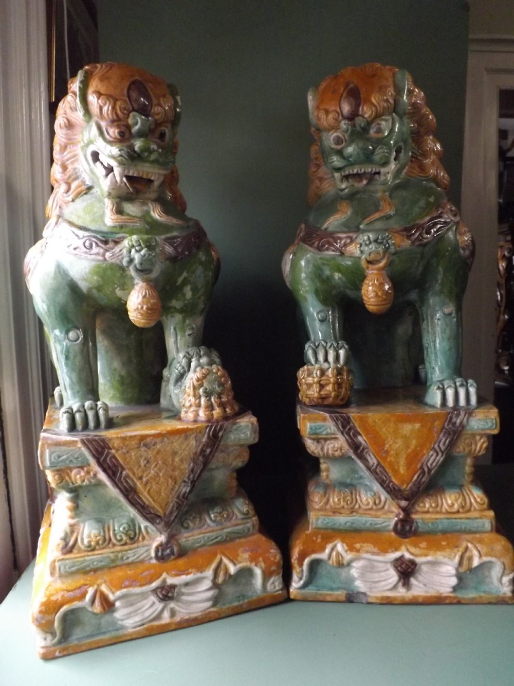 Pair of early C20th Chinese 'sancai'-glazed terracotta Buddhistic temple dogs.