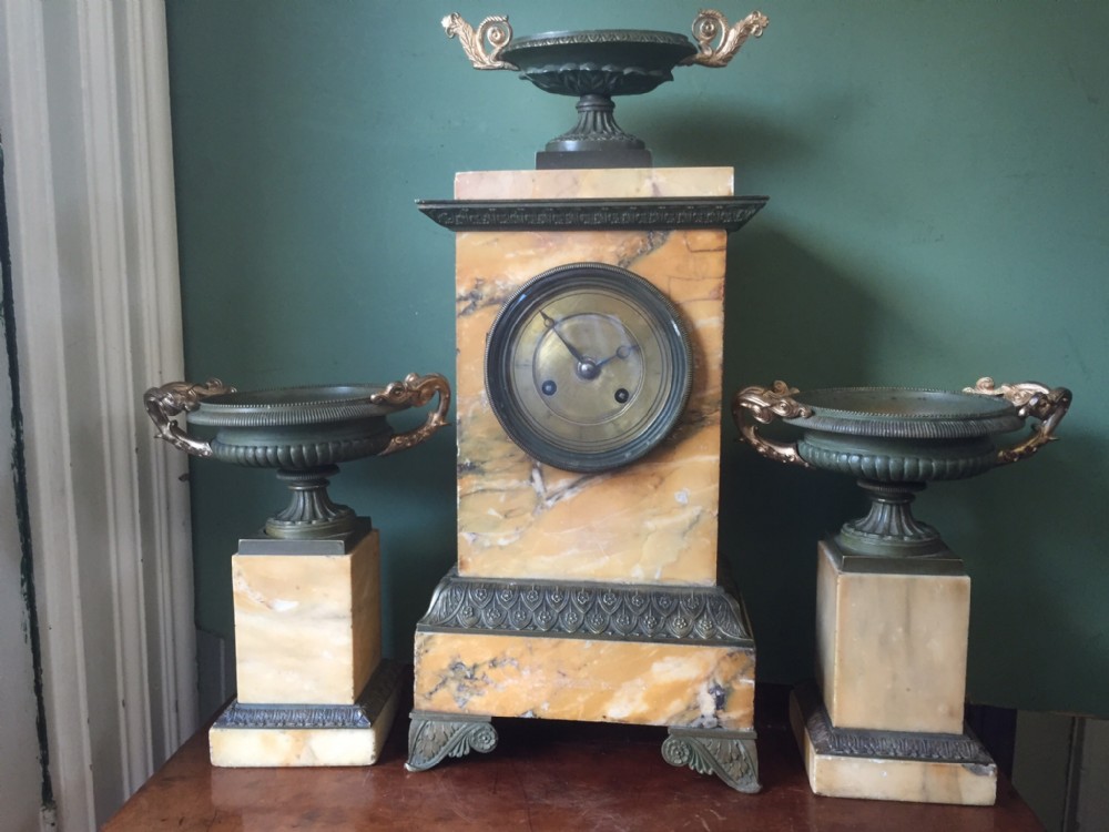 Early C19th French Charles X period siena marble and patinated bronze clock garniture.
