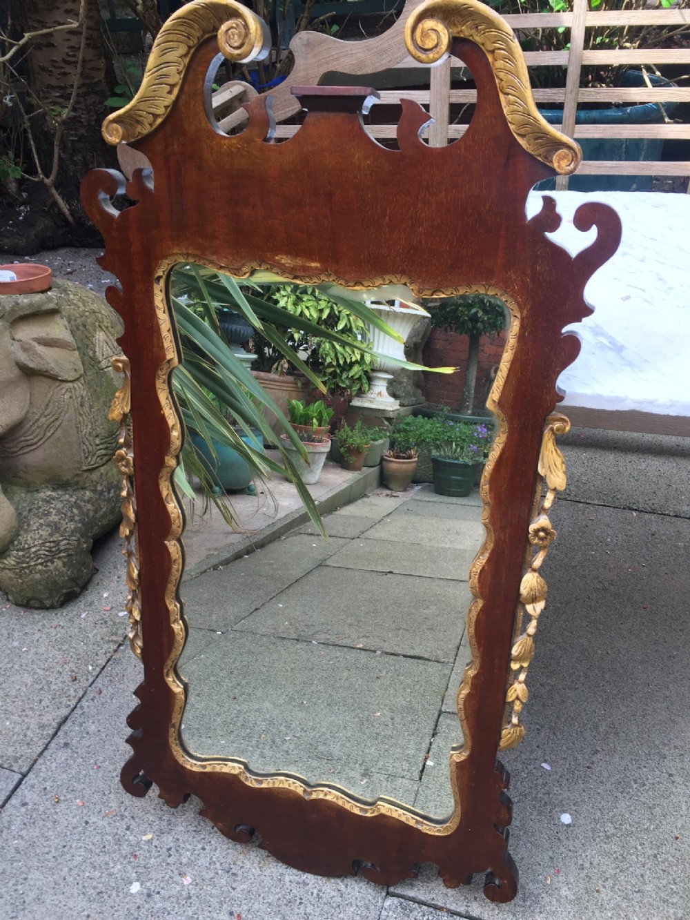 C19th George II revival style mahogany and parcel-gilt fret carved mirror.