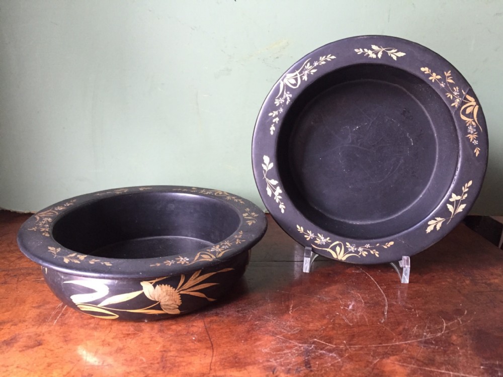 Pair of early C19th Regency period papier-mache wine-bottle coasters.