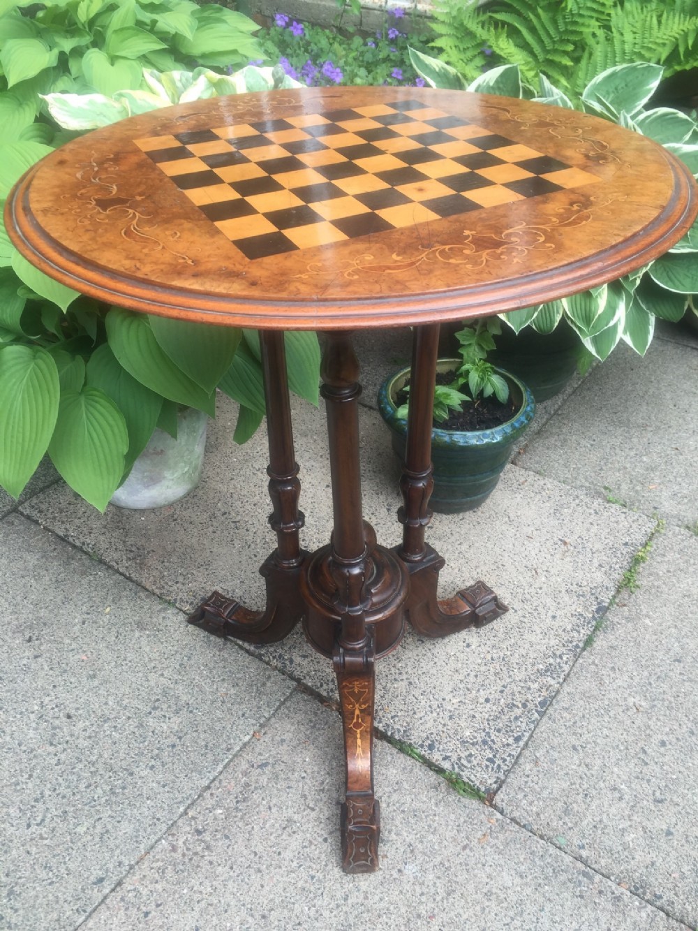 C19th Victorian period walnut circular occasional table with inlaid chequer-board games top.