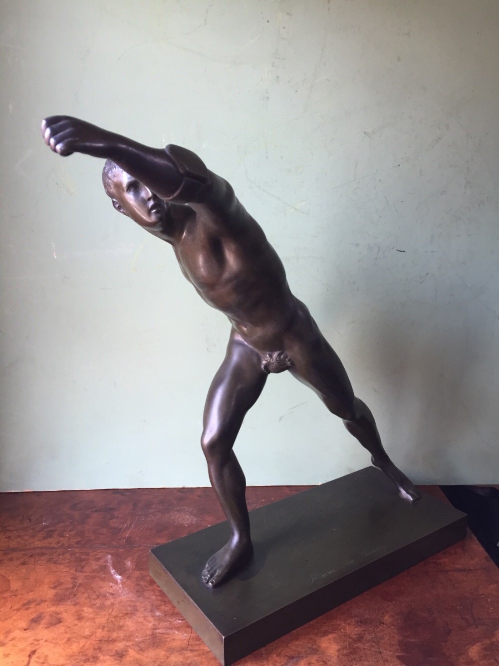 A nineteenth-century dark brown patinated bronze study depicting the Borghese Gladiator posed dynamically on an integral rectangular base.