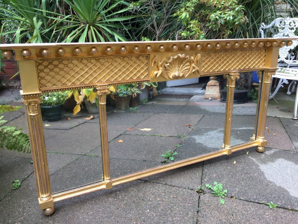 Early C19th late George III period carved gilt-wood 3-plate 'landscape' over-mantel mirror.