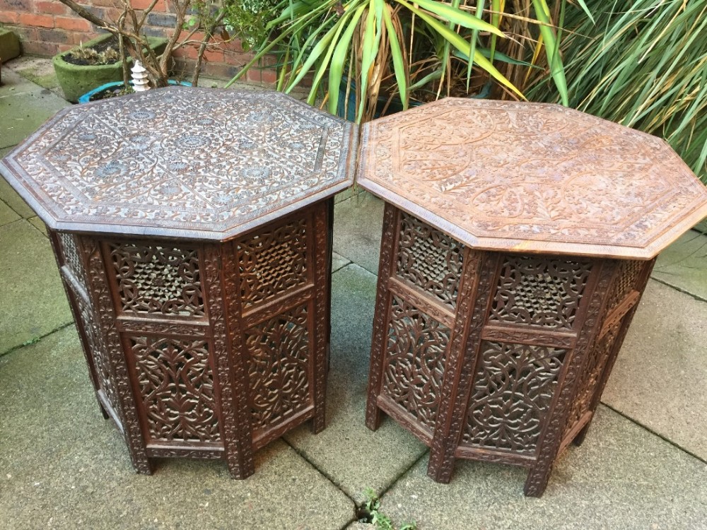 Matched 'pair' of late C19th Anglo-Indian carved shisham octagonal tables on folding bases.