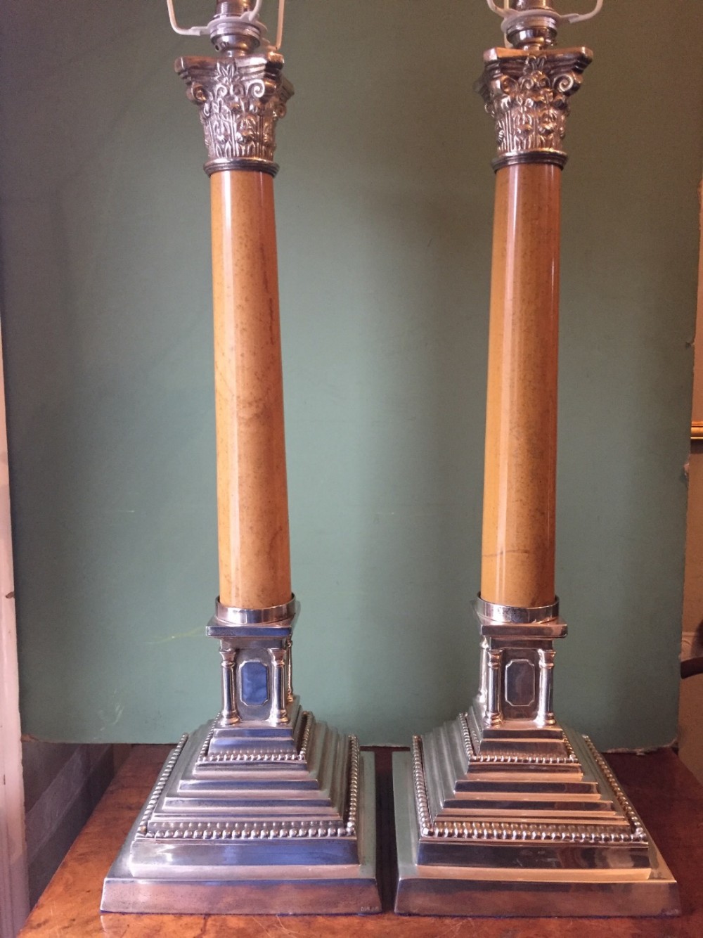 Pair of early C20th silver-plated and marble column Corinthian-capped classical-style table lamps.
