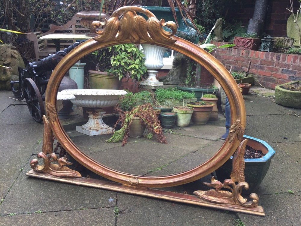 Mid C19th carved giltwood oval-framed overmantel mirror with unusual carved fern motif decoration.