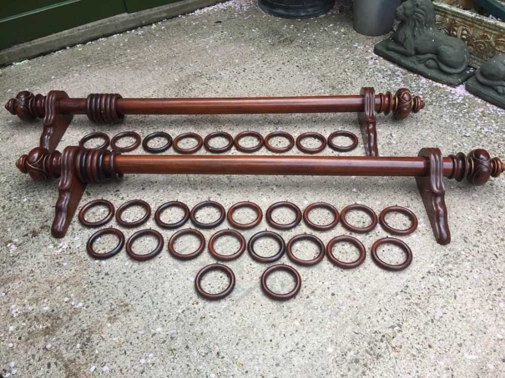 Pair of impressive mid C19th mahogany and parcel-gilt curtain-poles with rings and brackets.