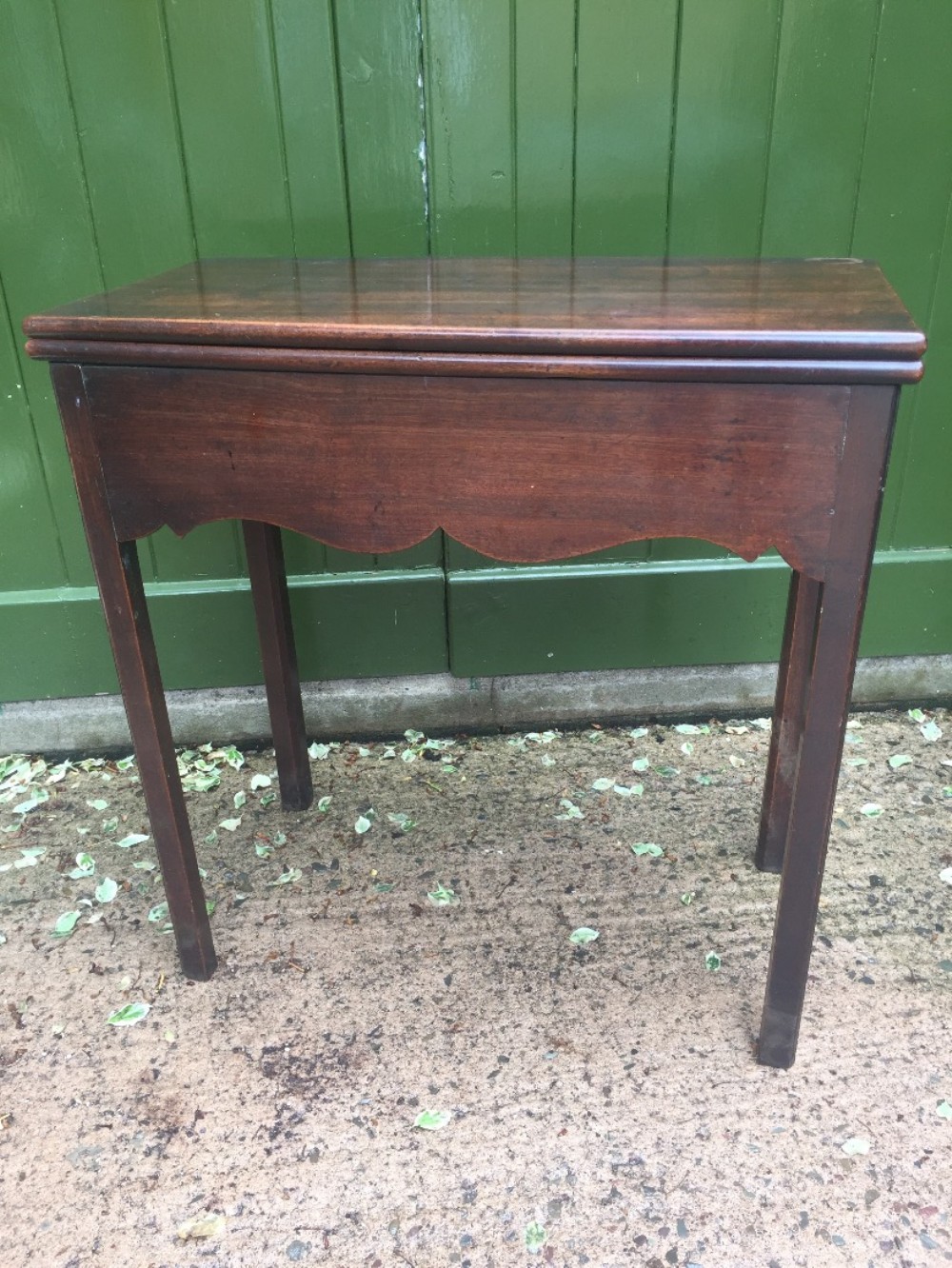 Mid C18th George II period mahogany fold-over tea or side table of diminutive proportions.
