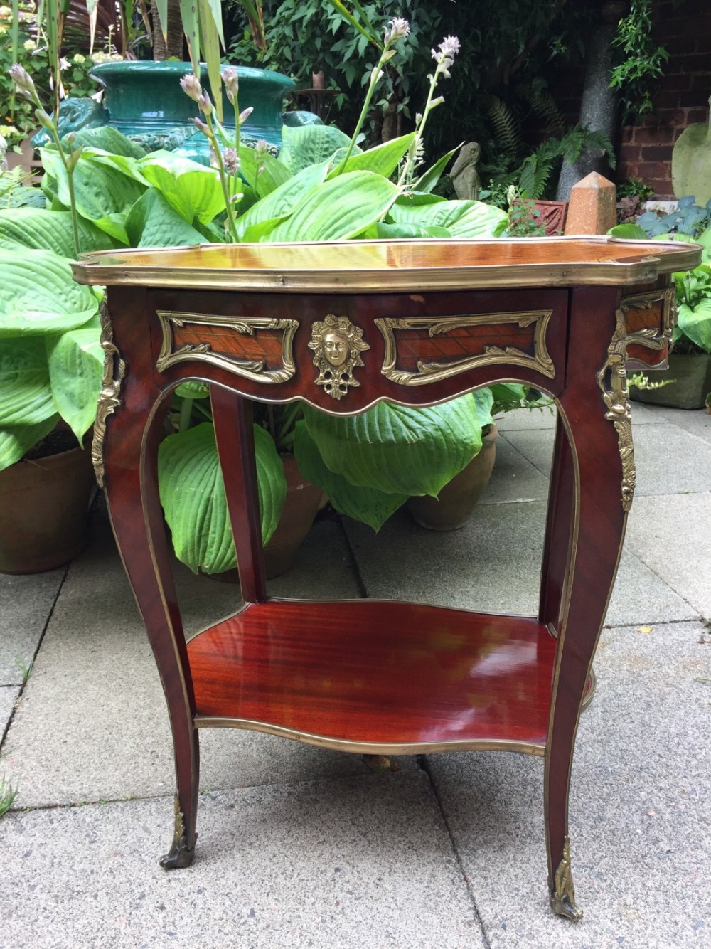 Early C20th French gilt-brass mounted mahogany and kingwood table of Louis XVI design.