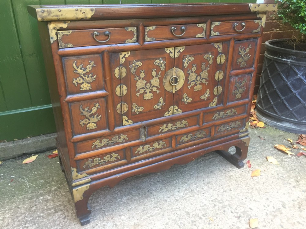 Late C19th Korean brass-bound elm cabinet or 'Tansu' of low proportions .
