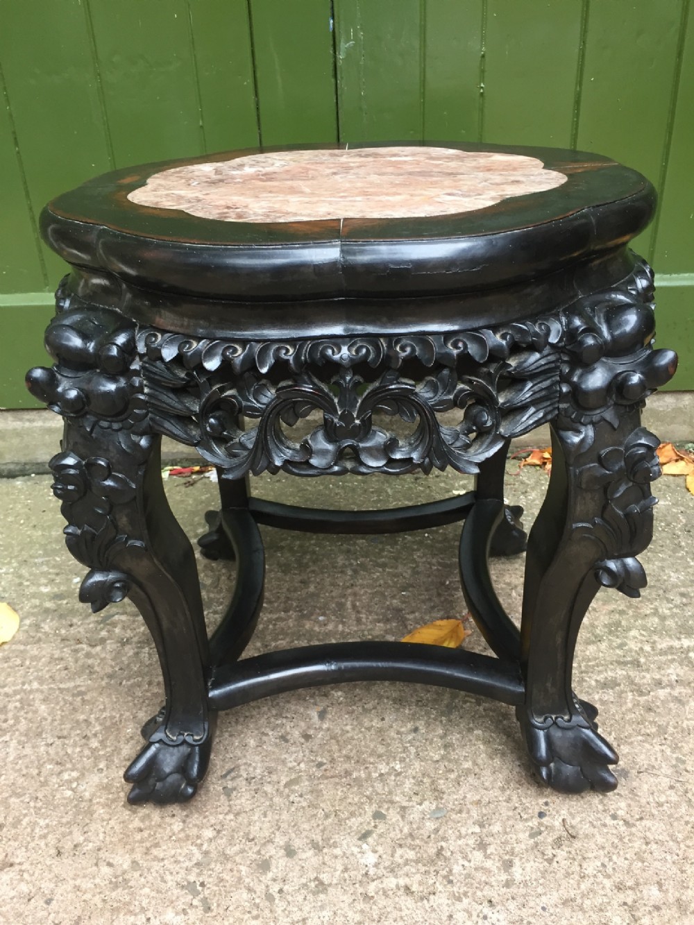 Late C19th Chinese Qing Dynasty carved hardwood framed low stand or table with shaped inset rouge marble top.