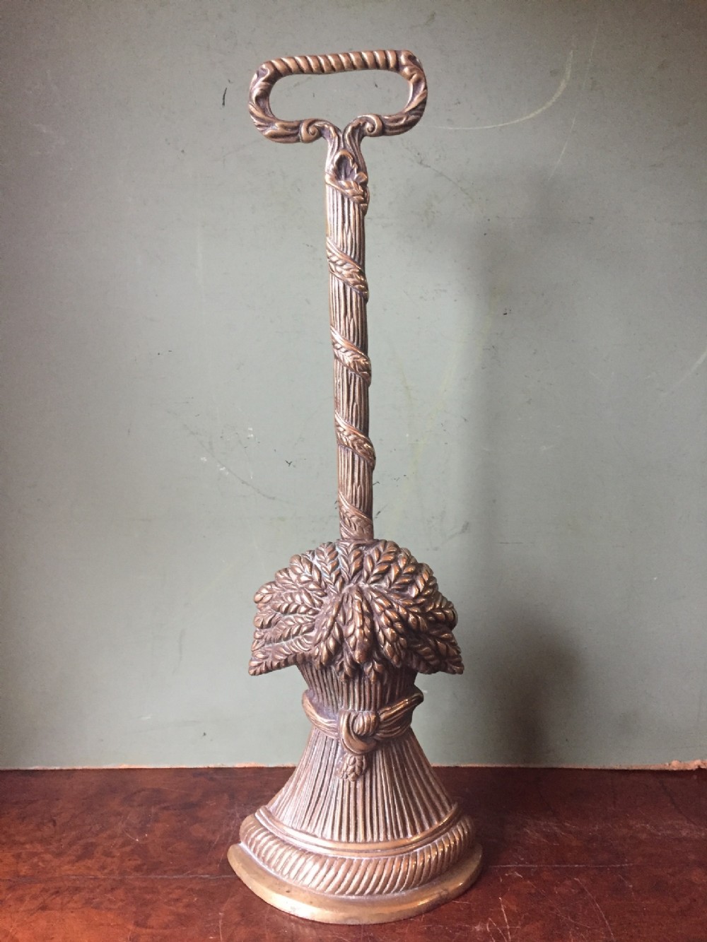 Early C19th Regency period cast brass door-porter or door-stop , the base modelled as a sheaf of wheat.