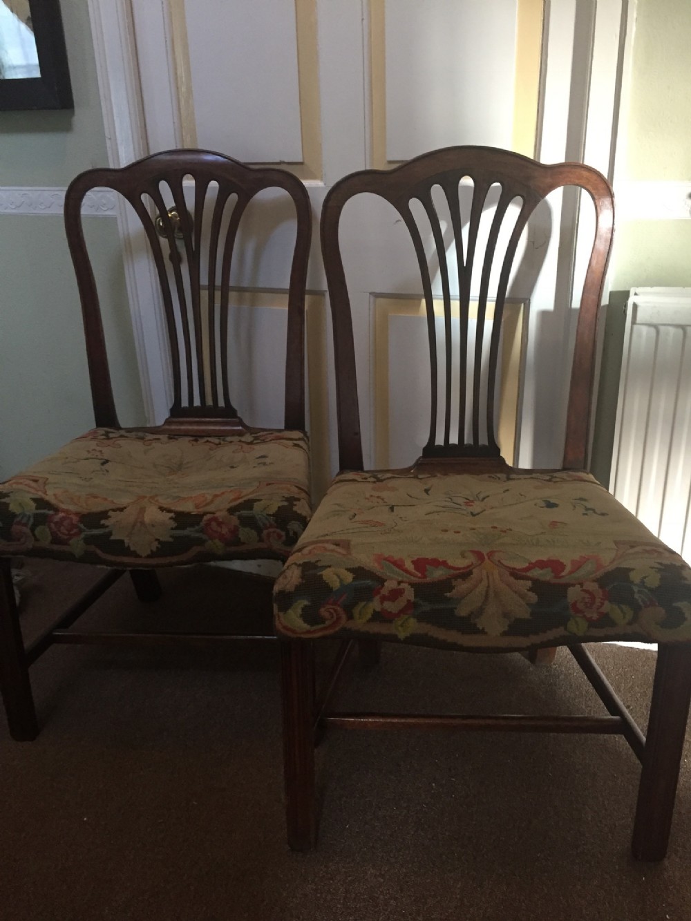 Pair of C18th George III period mahogany side chairs with original needle-work seat covers .