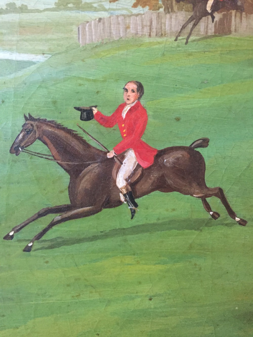 An early 19th-century rectangular papier-mache tray featuring a gilded scrollwork border and a central hand-painted scene of horsemen and hounds engaged in a fox hunt across a countryside landscape. View VII