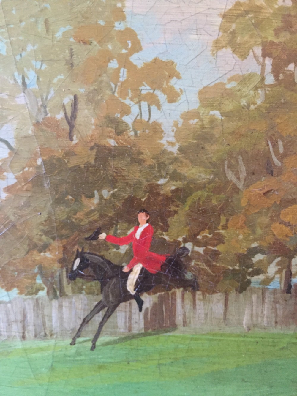An early 19th-century rectangular papier-mache tray featuring a gilded scrollwork border and a central hand-painted scene of horsemen and hounds engaged in a fox hunt across a countryside landscape. View X