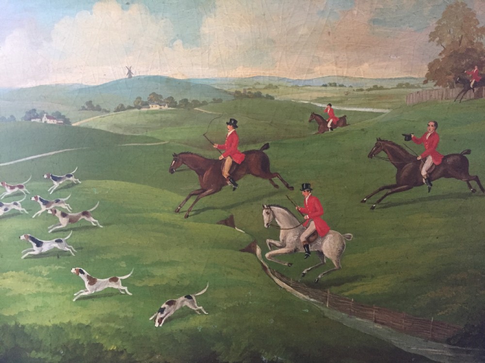 An early 19th-century rectangular papier-mache tray featuring a gilded scrollwork border and a central hand-painted scene of horsemen and hounds engaged in a fox hunt across a countryside landscape. View XVIII