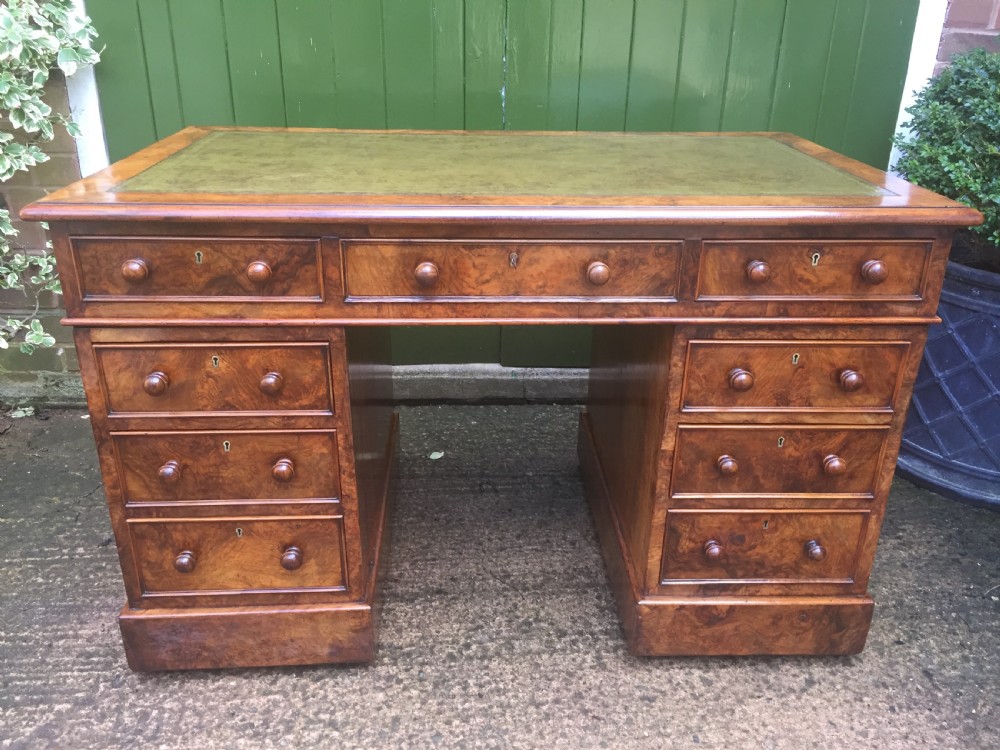 Exceptional quality mid-C19th Victorian burr-walnut pedestal desk of practical proportions.