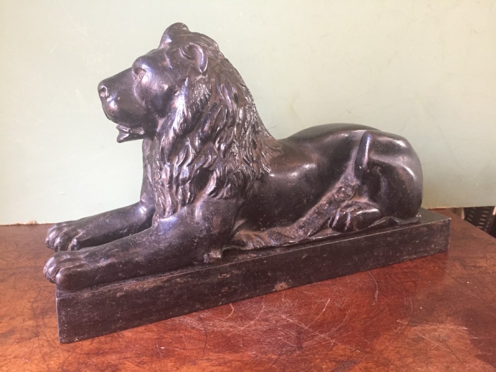 Late C19th cast-iron model of a recumbent lion on a rectangular plinth base. View II