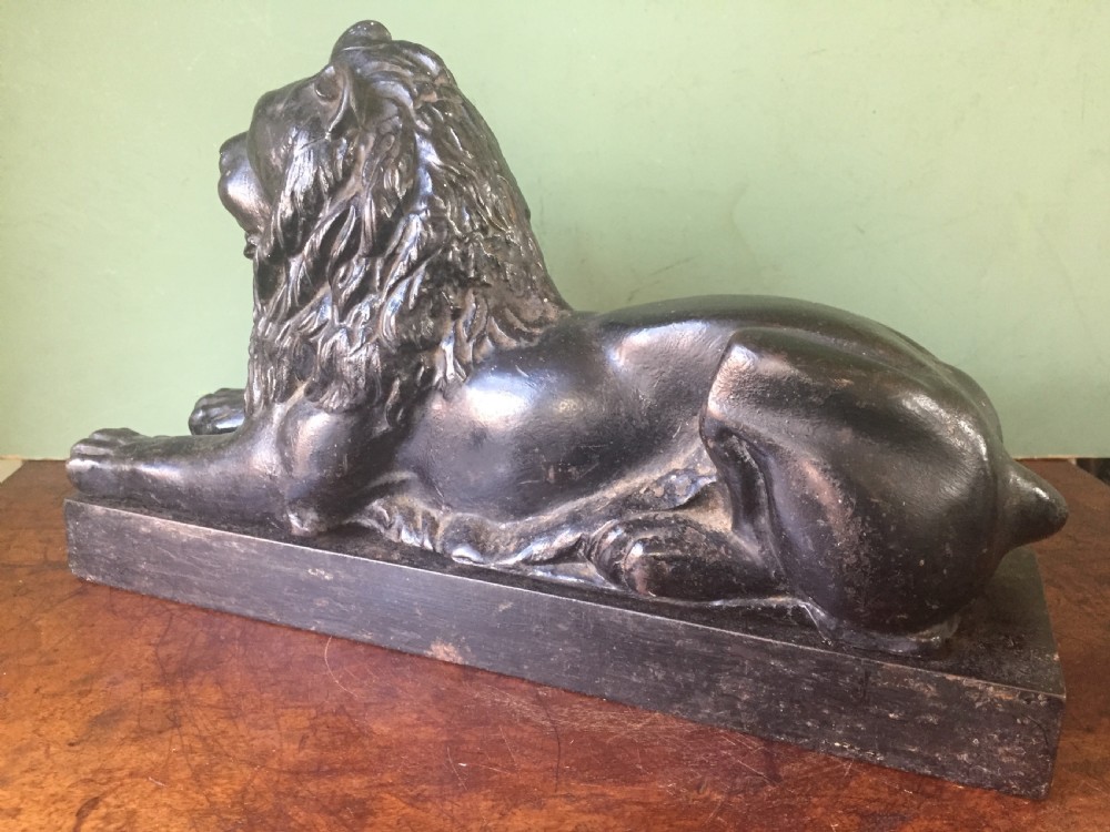 Late C19th cast-iron model of a recumbent lion on a rectangular plinth base. View III
