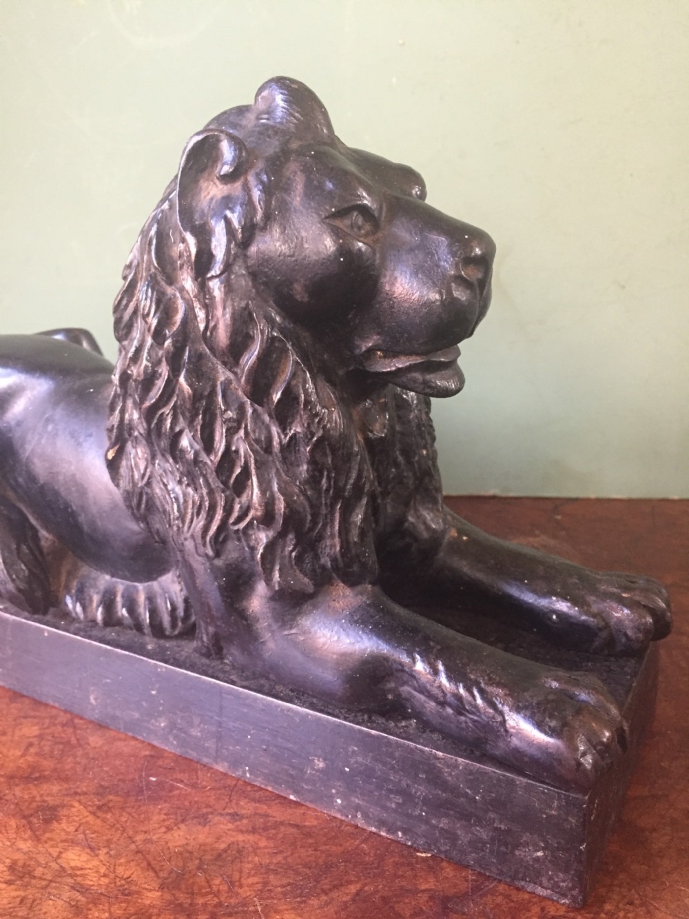 Late C19th cast-iron model of a recumbent lion on a rectangular plinth base. View V