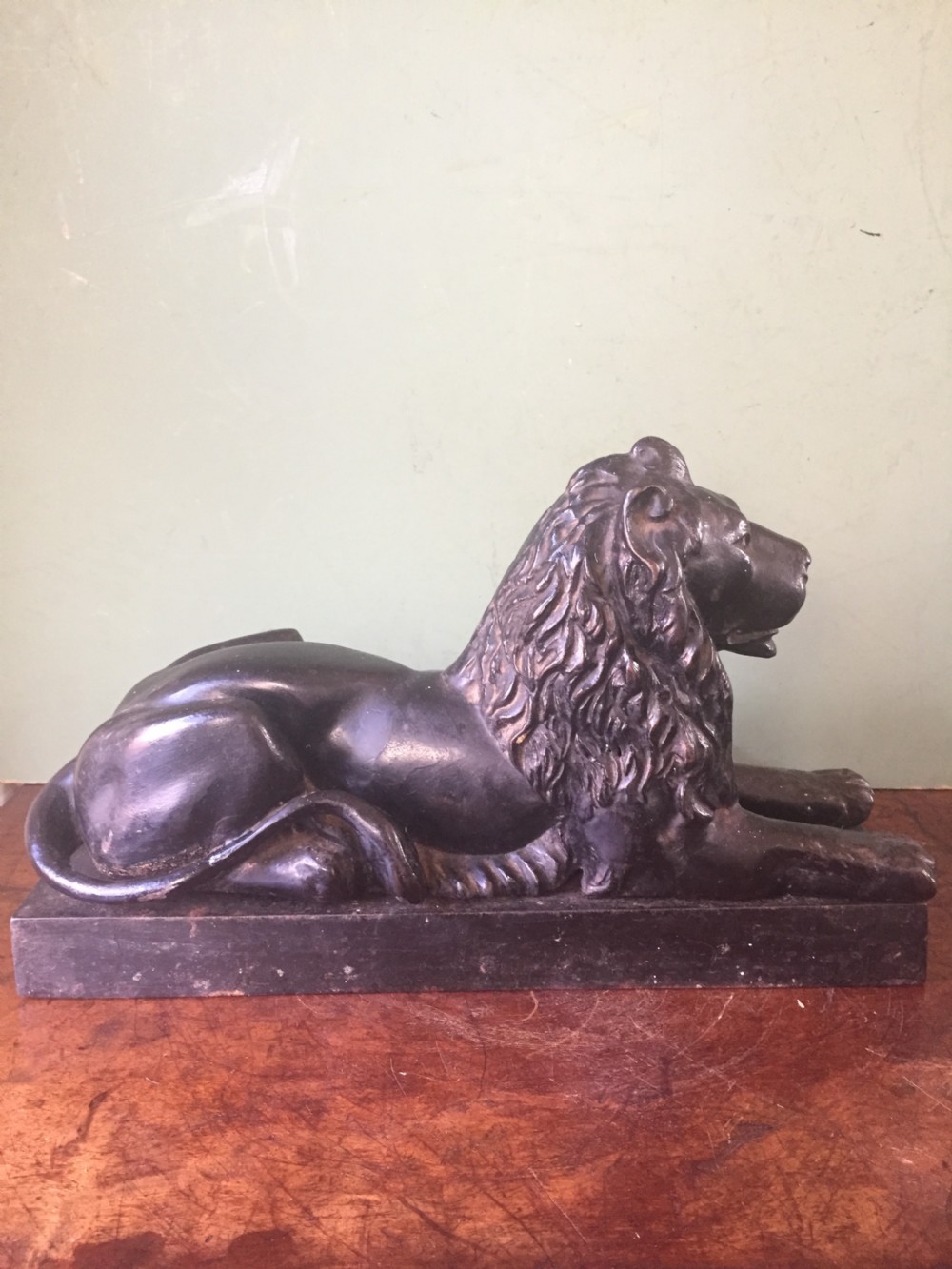 Late C19th cast-iron model of a recumbent lion on a rectangular plinth base. View VI