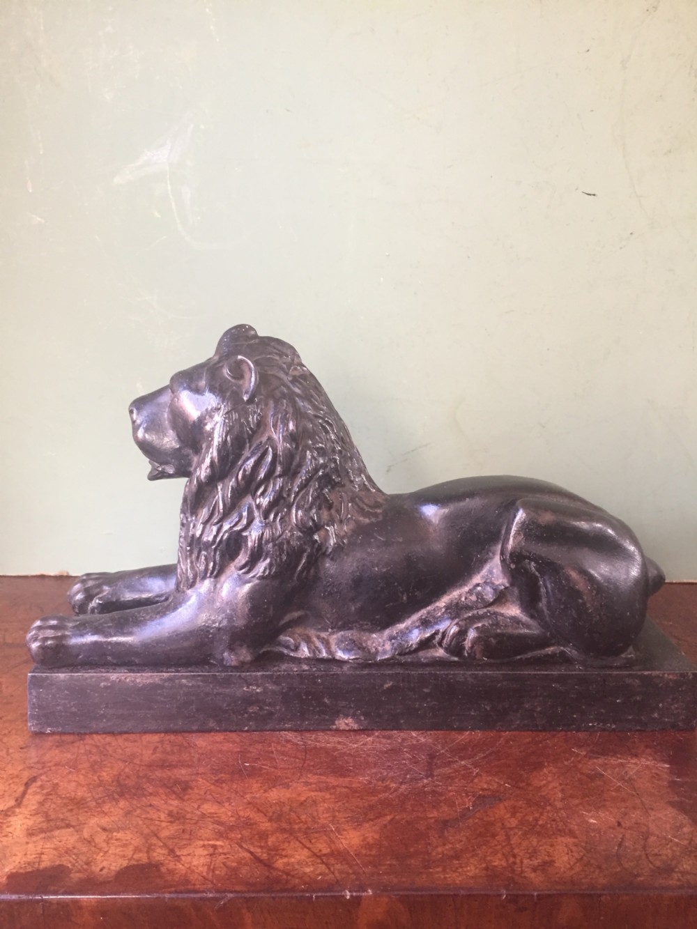 Late C19th cast-iron model of a recumbent lion on a rectangular plinth base. View IX