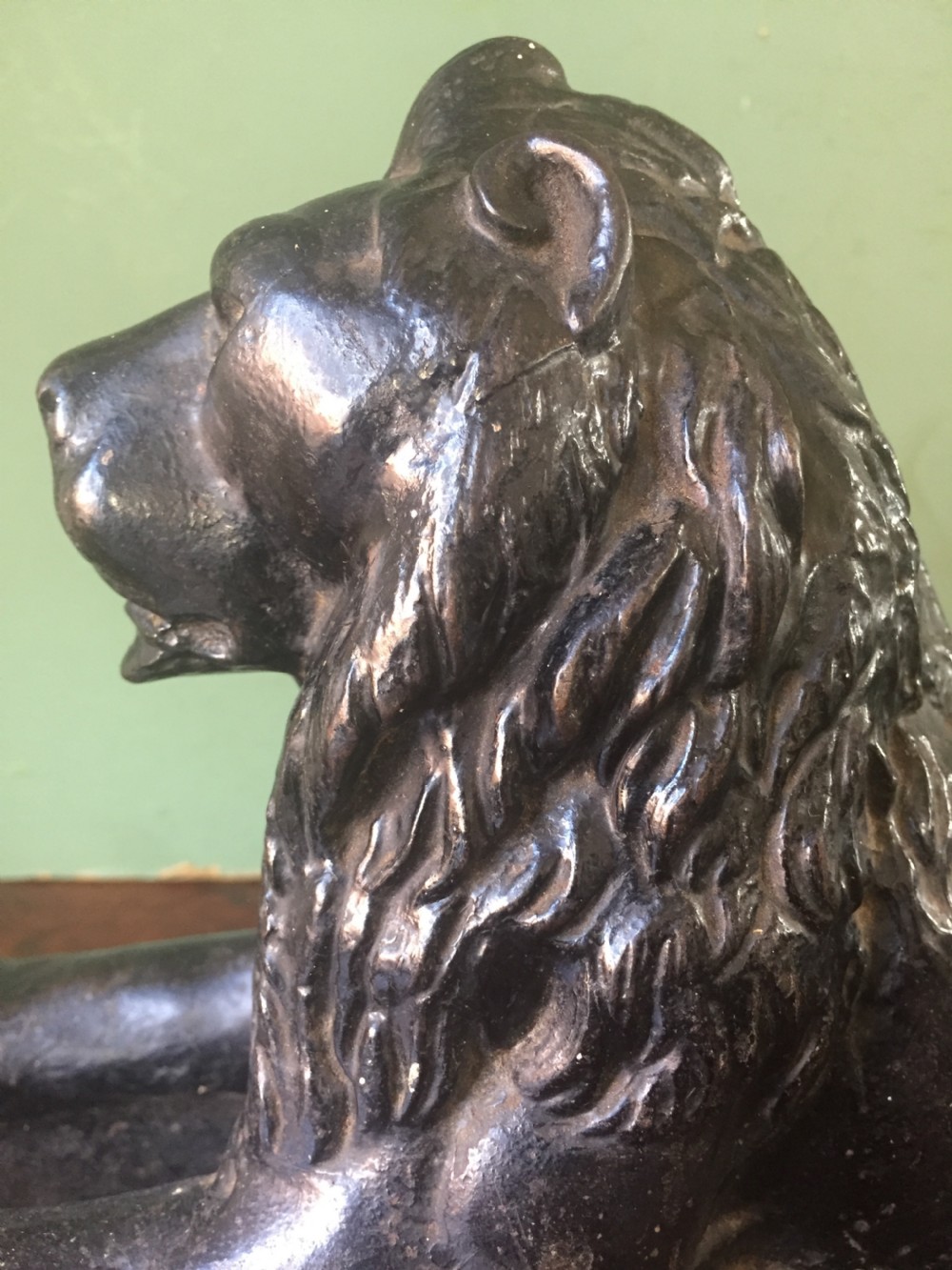 Late C19th cast-iron model of a recumbent lion on a rectangular plinth base. View X