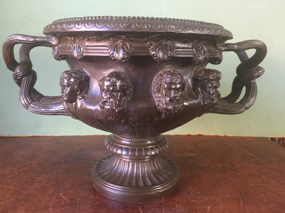 A nineteenth-century dark bronze reduction of the Albani Vase featuring classical sculpted masks along the body, intertwined handles, and a pedestal base. View III