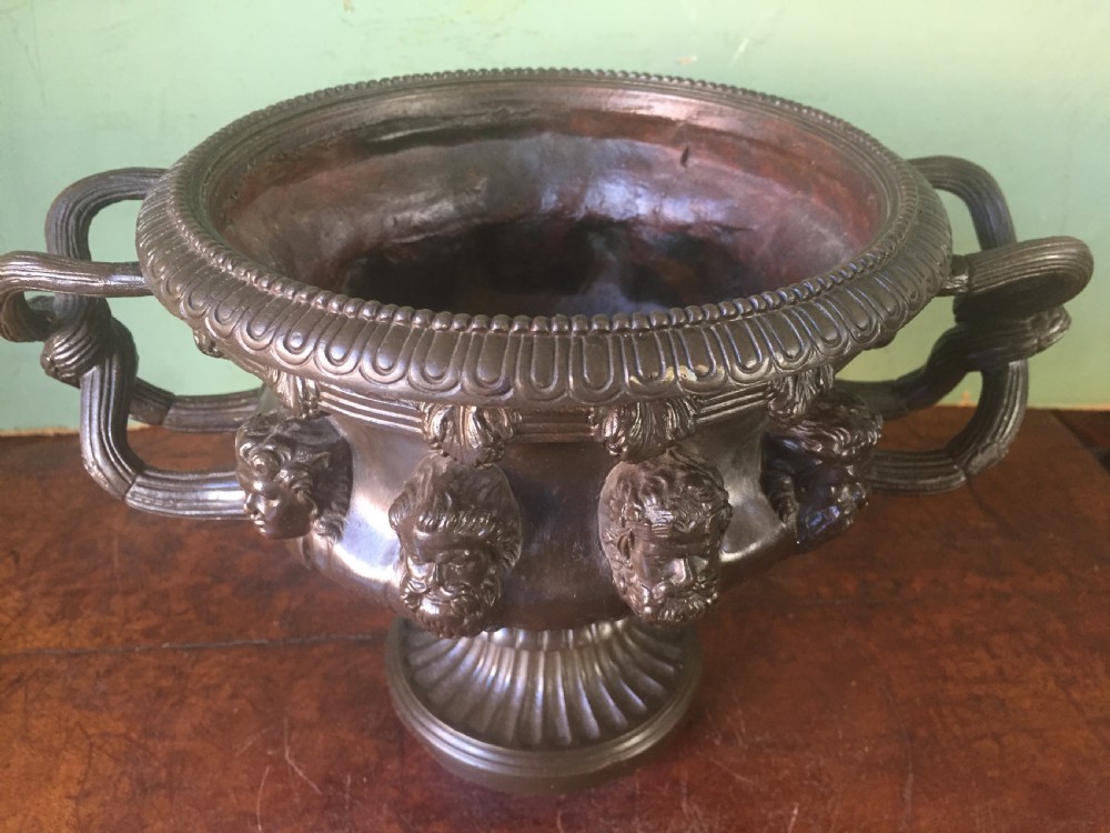 A nineteenth-century dark bronze reduction of the Albani Vase featuring classical sculpted masks along the body, intertwined handles, and a pedestal base. View IV