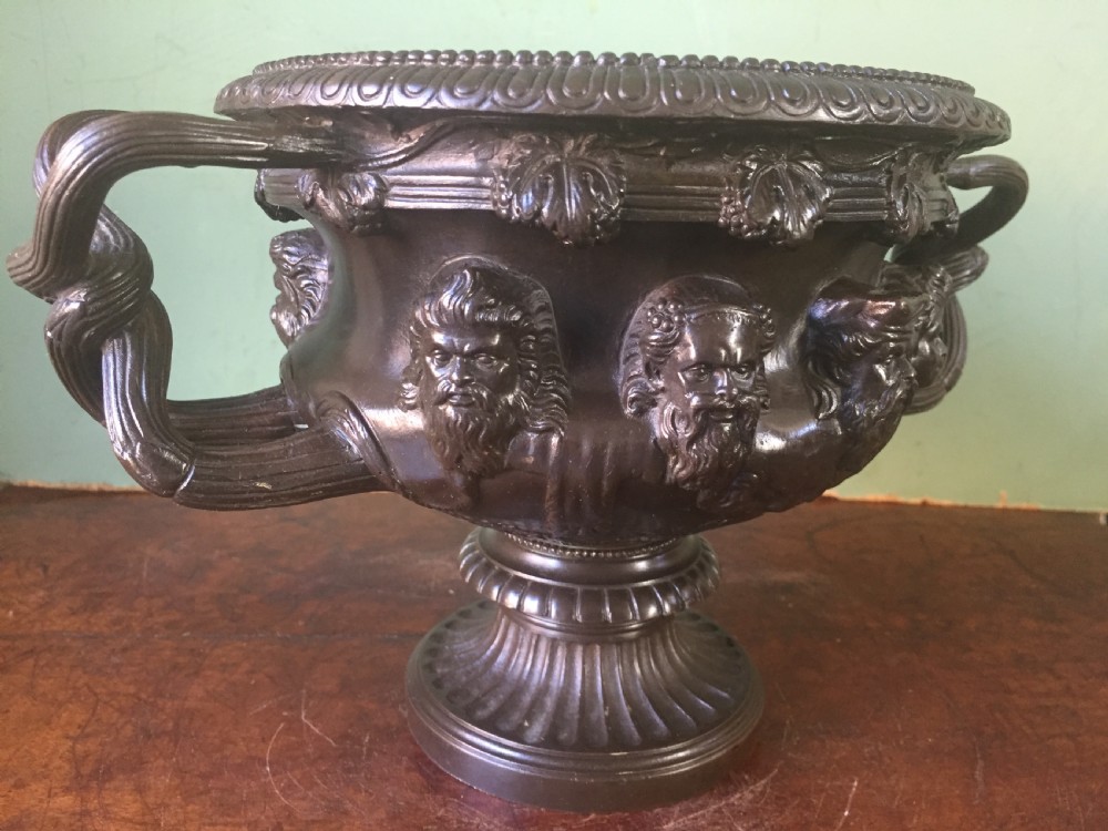 A nineteenth-century dark bronze reduction of the Albani Vase featuring classical sculpted masks along the body, intertwined handles, and a pedestal base. View VIII
