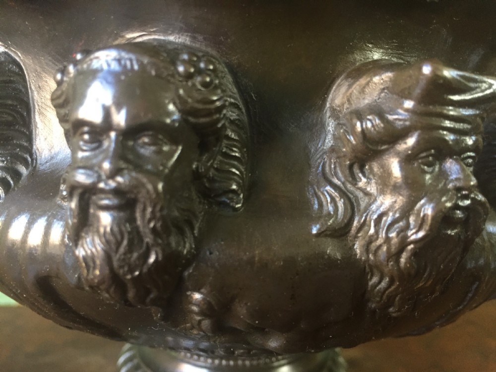 A nineteenth-century dark bronze reduction of the Albani Vase featuring classical sculpted masks along the body, intertwined handles, and a pedestal base. View IX